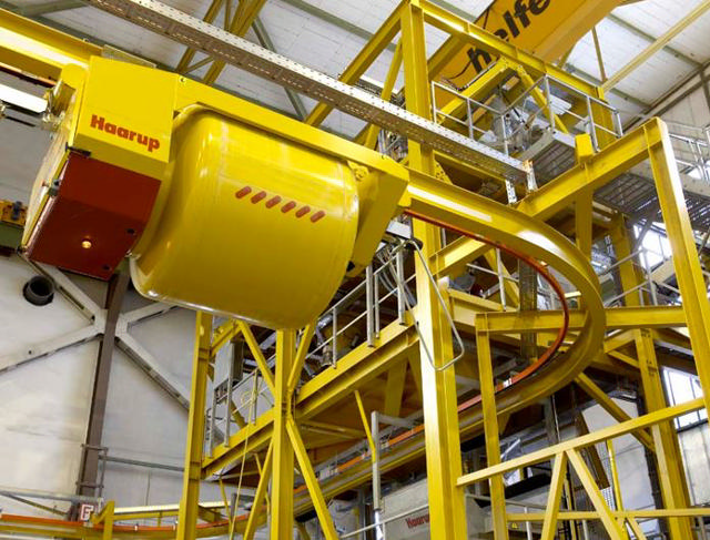 Prduct photo of a yellow mono rail concrete travelling bucket.