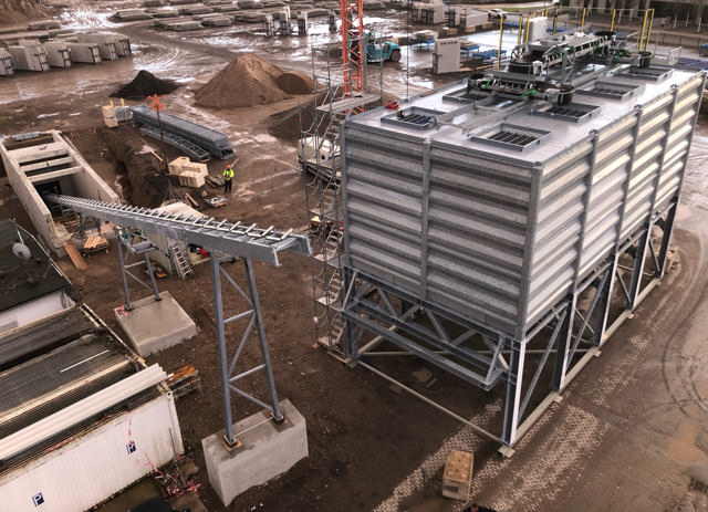 Eight aggregate bins shown on a construction site.
